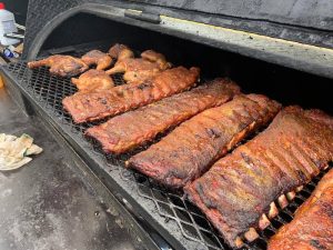 Steg's BBQ brisket and chicken on the grill.